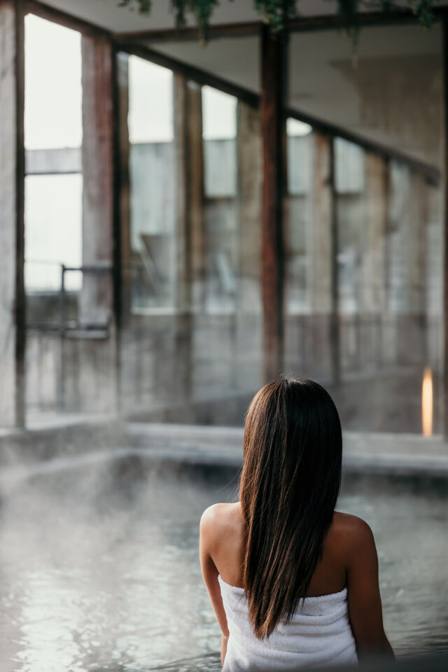 Woman sitting next to the bath