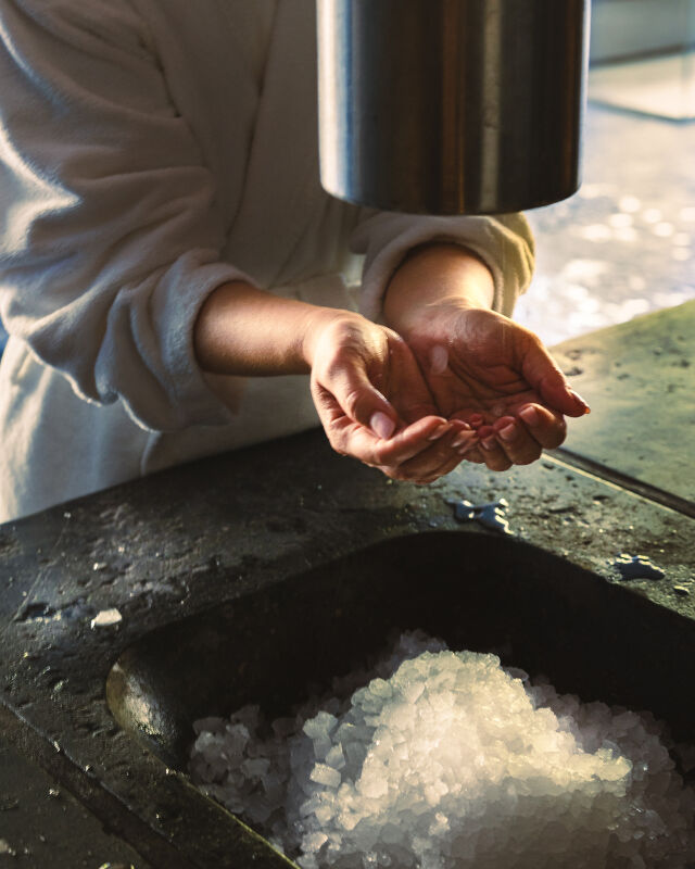 Woman catching ice cubes with bare hands